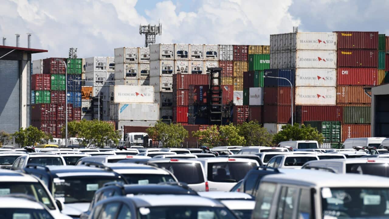 Shipping containers and new imported cars at the Port of Brisbane