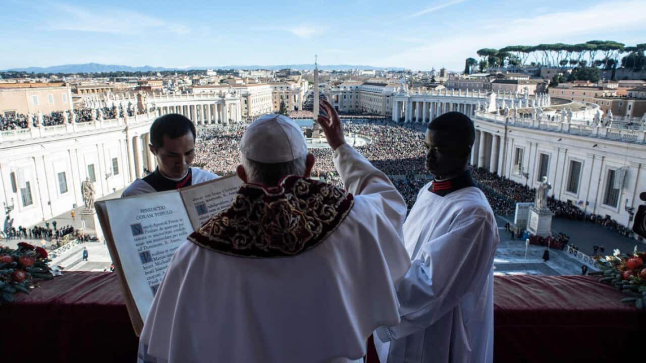 Pope Francis (C) delivering the traditional Urbi et Orbi Christmas Day blessing from the central balcony of St. Peter's Basilica at the Vatican, 25 December 2018.