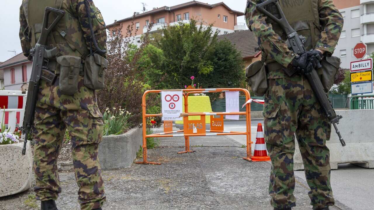 Swiss soldiers guard the border behind concrete blocks as an additional measure at the Swiss-French border of Pierre-a-Bochet 21 April 2020.