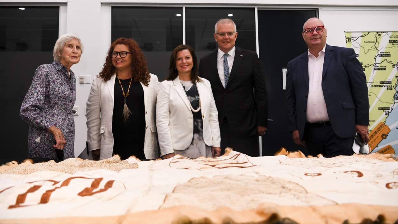 Heather Henderson, Jodie Sizer, Jenny Morrison, Scott Morrison and Craig Ritchie look at Indigenous artefacts