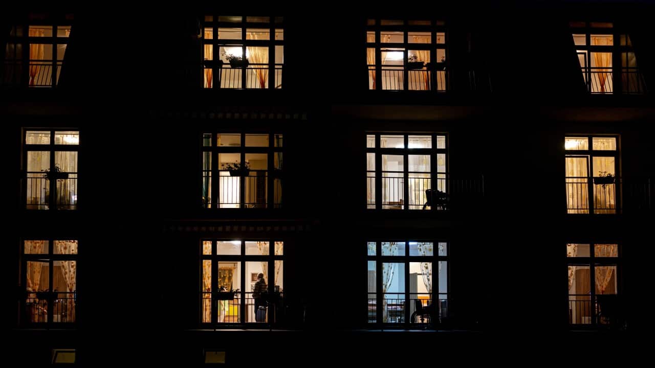 Illuminated windows of night house with people inside