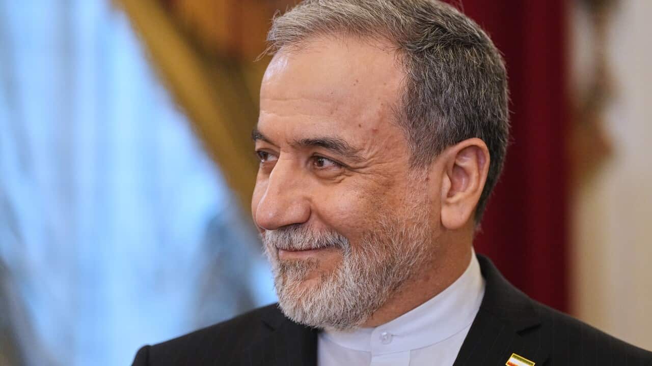 A man looks to his right as he smiles