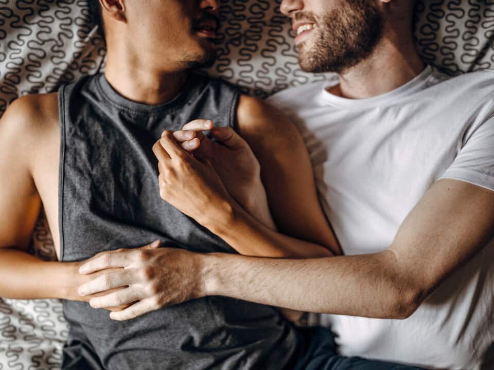 Loving gay couple in bed