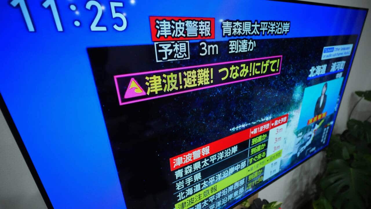 A tsunami warning is displayed on a television in Yokohama, near Tokyo, Monday, Dec. 8, 2025, after a strong earthquake hits off Japanese northern coast, tsunami alert issued.