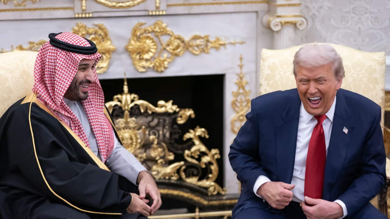 Donald Trump and Saudi Crown Prince Mohammed bin Salman sitting down and laughing together.