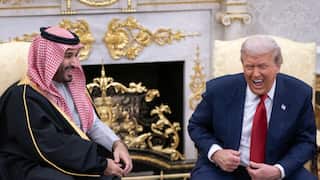 Donald Trump and Saudi Crown Prince Mohammed bin Salman sitting down and laughing together.