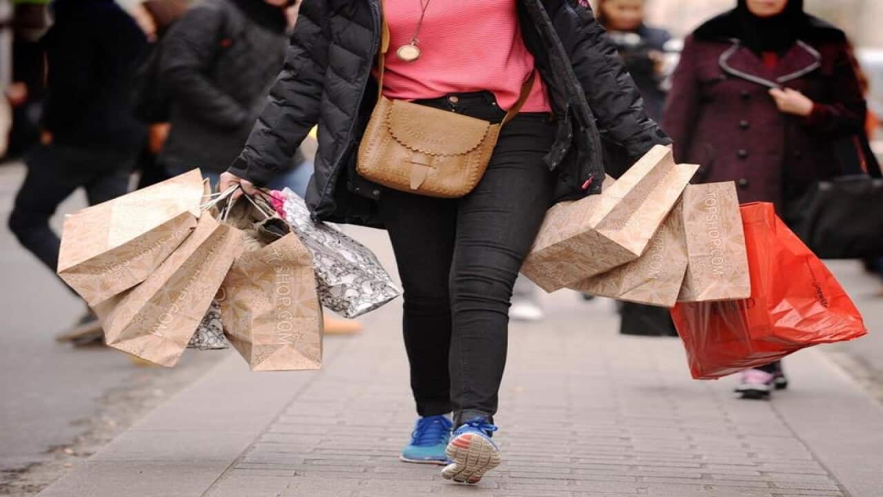 This is a file image of a woman carrying shopping bags.
