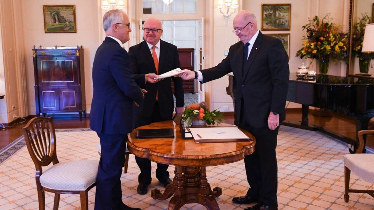 Australian Prime Minister Malcolm Turnbull (left) and Australian Attorney-General George Brandis receives the Marriage Amendment Bill 