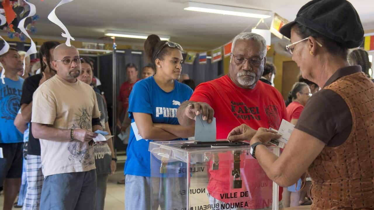 A man casts his vote at a polling station in Noumea, New Caledonia, as part of the 2018 independence referendum