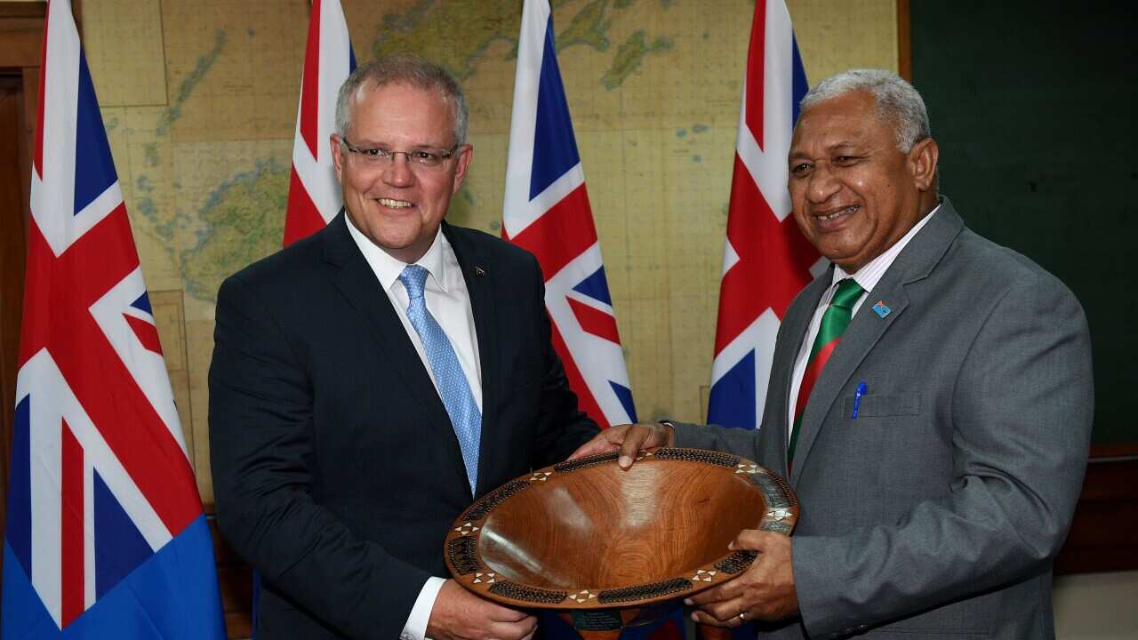 Mr Morrison and Fijian Prime Minister Frank Bainimarama in Suva, Fiji. Australia is trying to build influence in the Pacific with "soft-power" approaches.