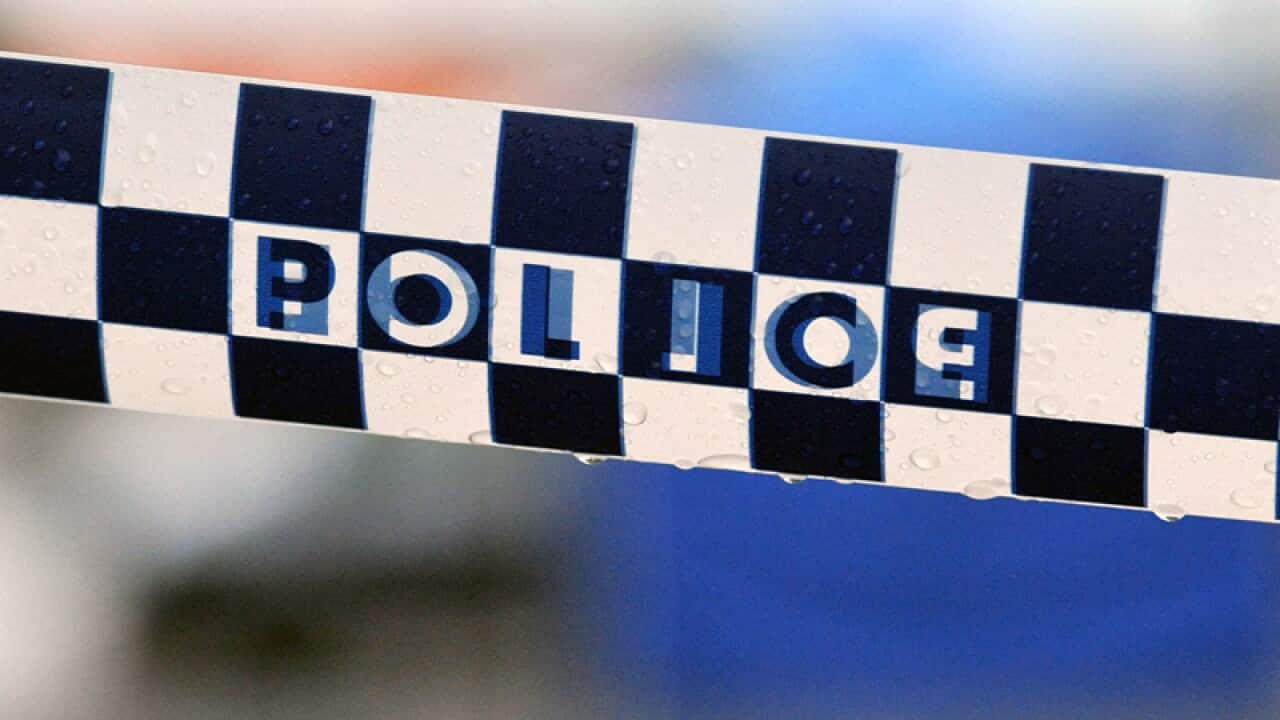 Police tape restricts access to a crime scene