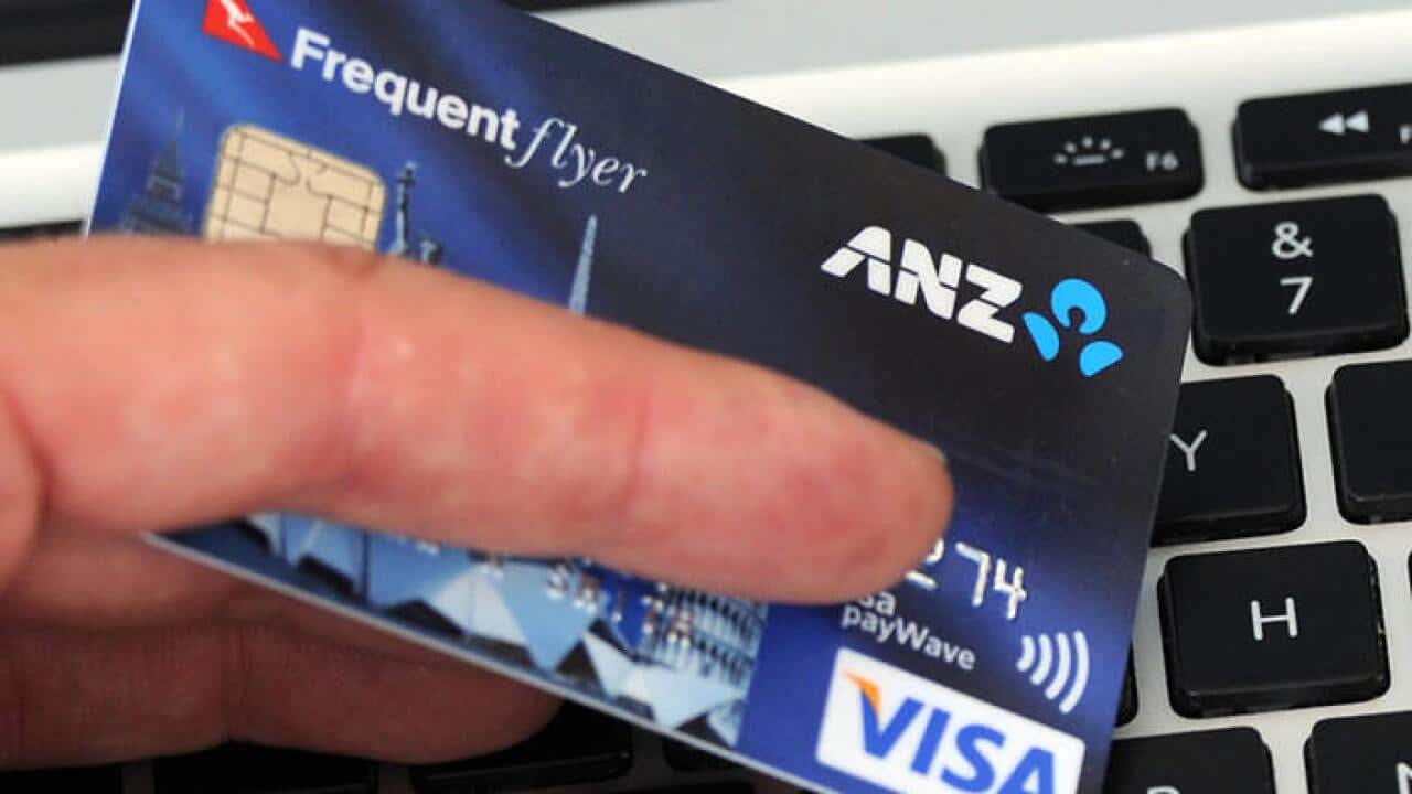 A credit card is held in front an online shopping site in Melbourne, Friday, Sept. 20, 2013. (AAP Image/Julian Smith) NO ARCHIVING