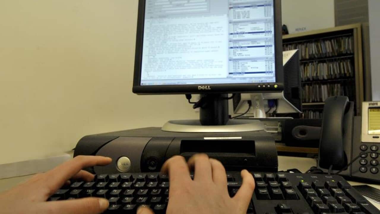Stock photo of office worker using a compute