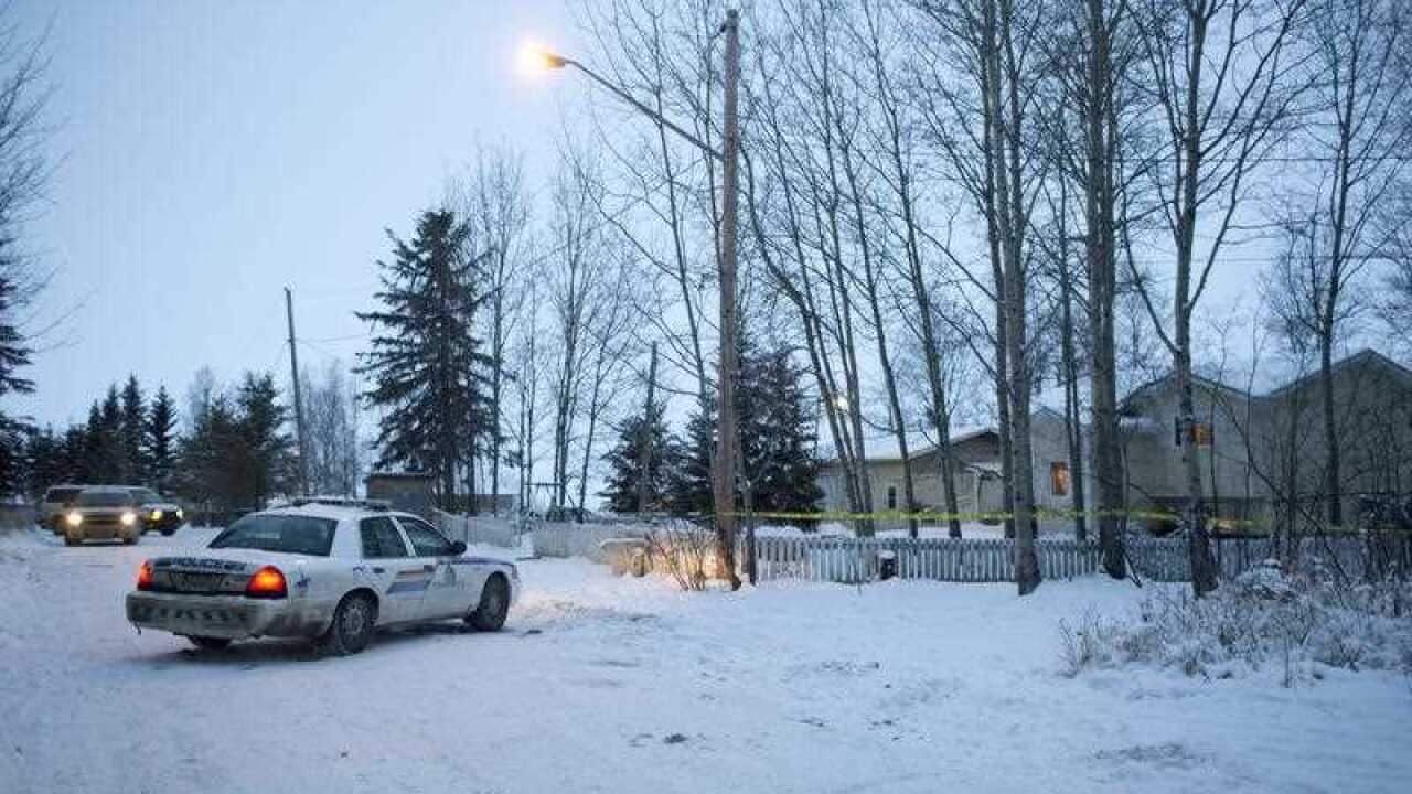 Police investigate a house where two people were killed Friday before the shooting at the La Loche, Saskatchewan, junior and senior high school.