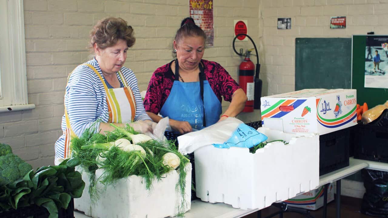 Volunteers prepare food for disadvantaged people