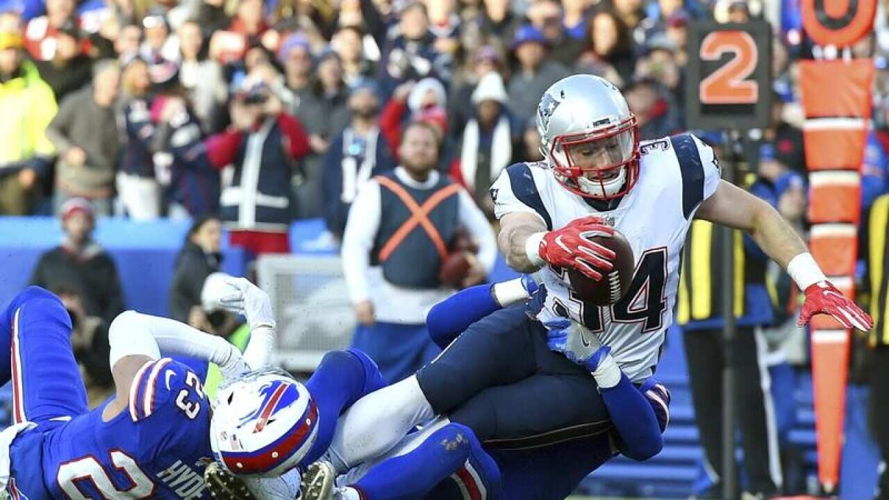 New England running back Rex Burkhead (R) dives for a touchdown