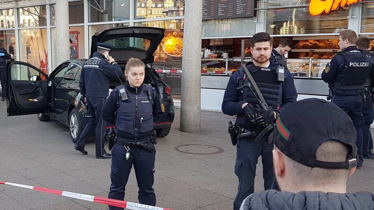 Police officers stand in front of a car in Heidelberg, Germany