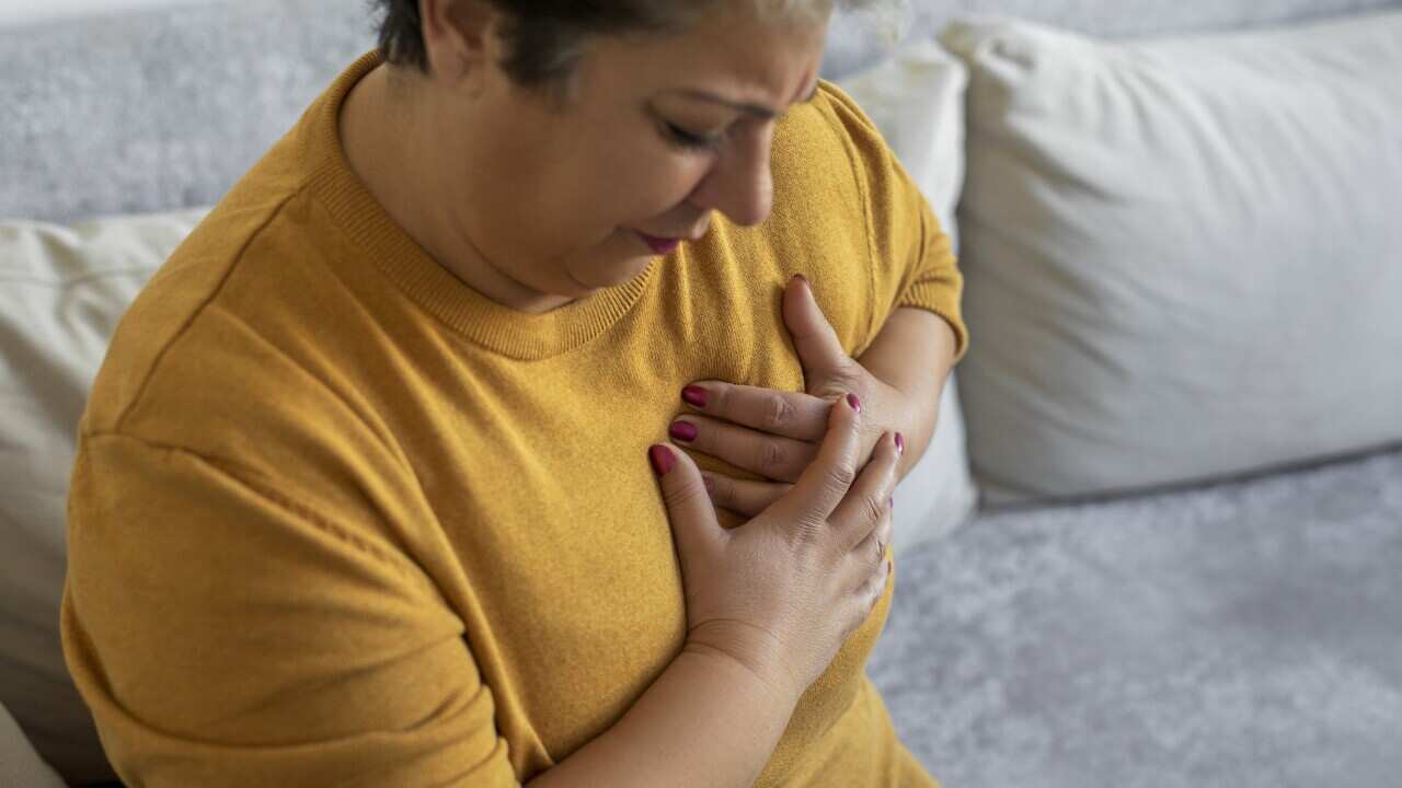 Woman painful grimace pressing the upper abdomen