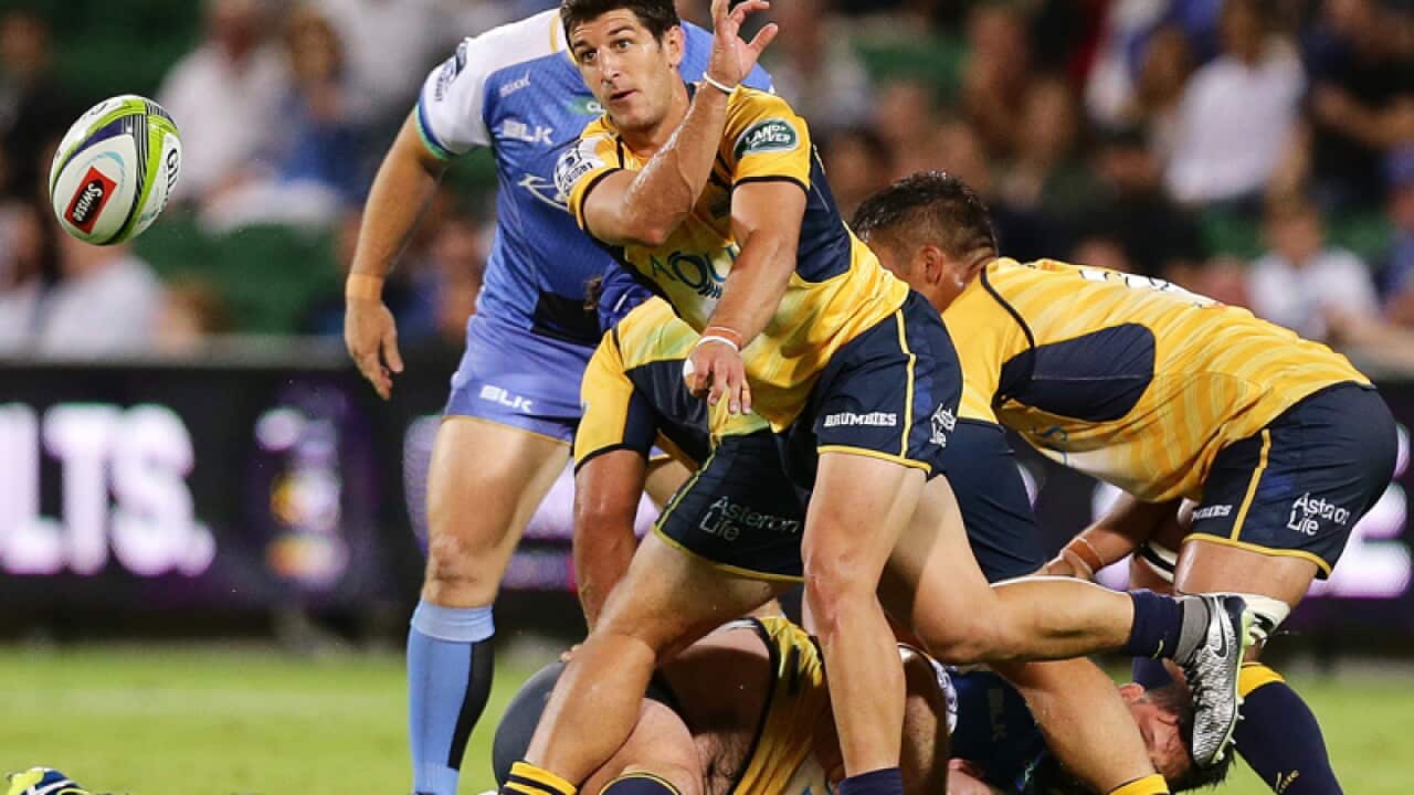 ACT Brumbies player Tomas Cubelli passes the ball from the scrum