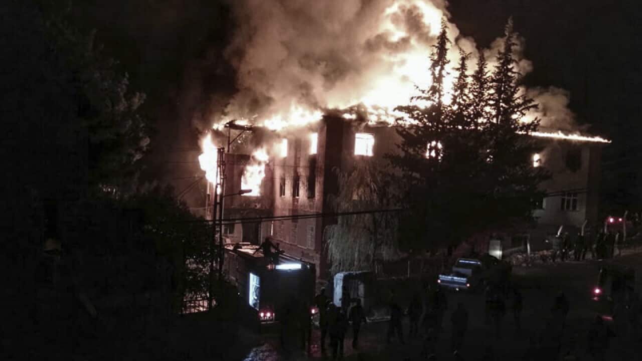 Flames rise from a fire in a school dormitory in Aladag, Turkey