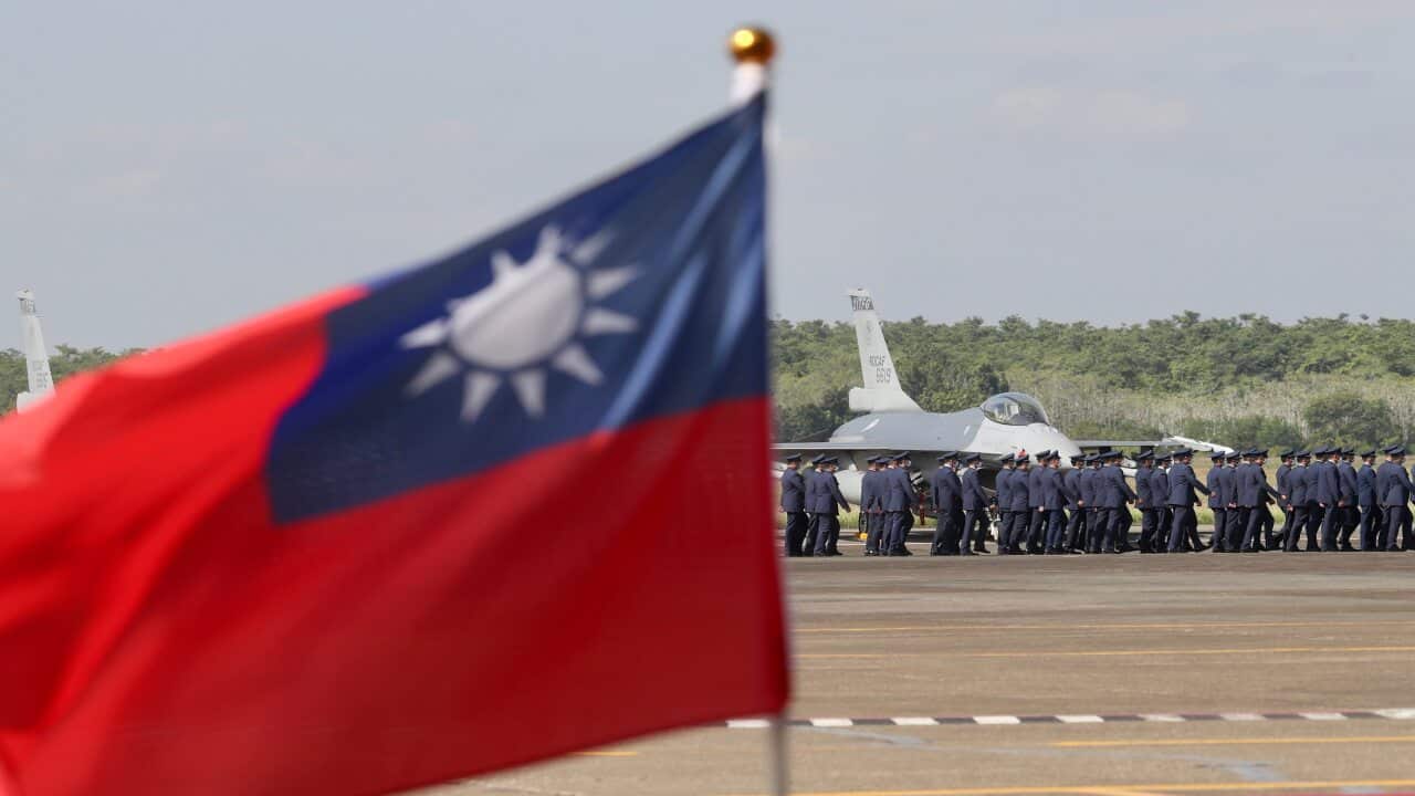 Taiwan Air Force officers march next to F-16V fighter jets at the tarmac during the commission ceremony inside the airbase of Chiayi, Taiwan, 18 November 2021.