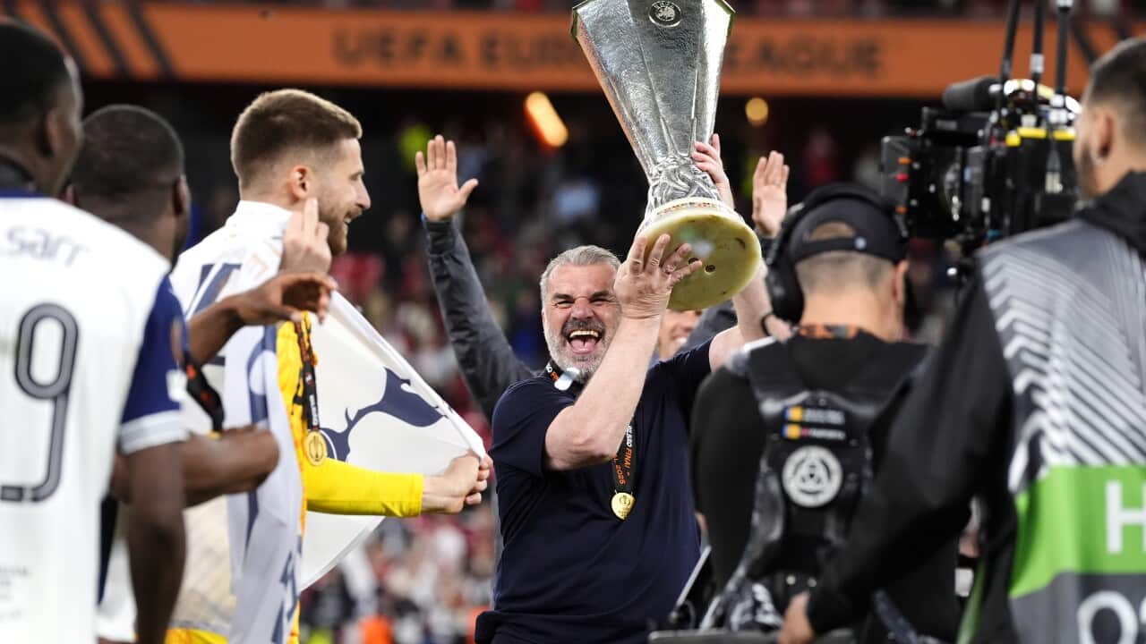 Tottenham Hotspur manager Ange Postecoglou (centre) celebrates with the trophy following victory in the UEFA Europa League final at the Estadio de San Mames in Bilbao, Spain