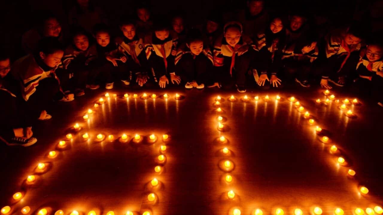 Students light candles to mark the Earth Hour, inspiring people to take action to protect and preserve the natural environment of the planet in north China.