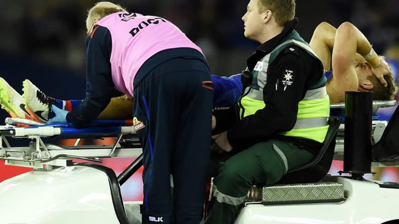 Western Bulldogs midfielder Mitch Wallis injures his leg