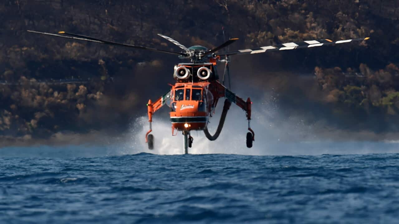 An Elvis helicopter picks up ocean water