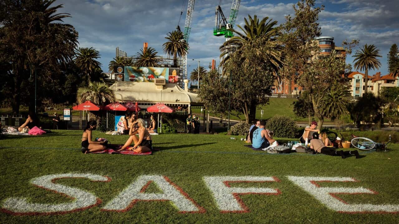 People enjoy the sun at St Kilda beach, Melbourne, while social distancing