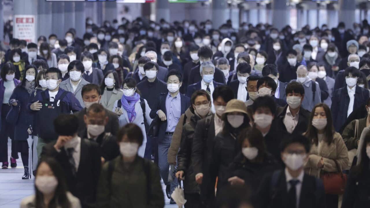 Commuters wearing face masks during rush hour in Shinagawa Ward, Tokyo, under a state of emegency on 13 April, 2020.