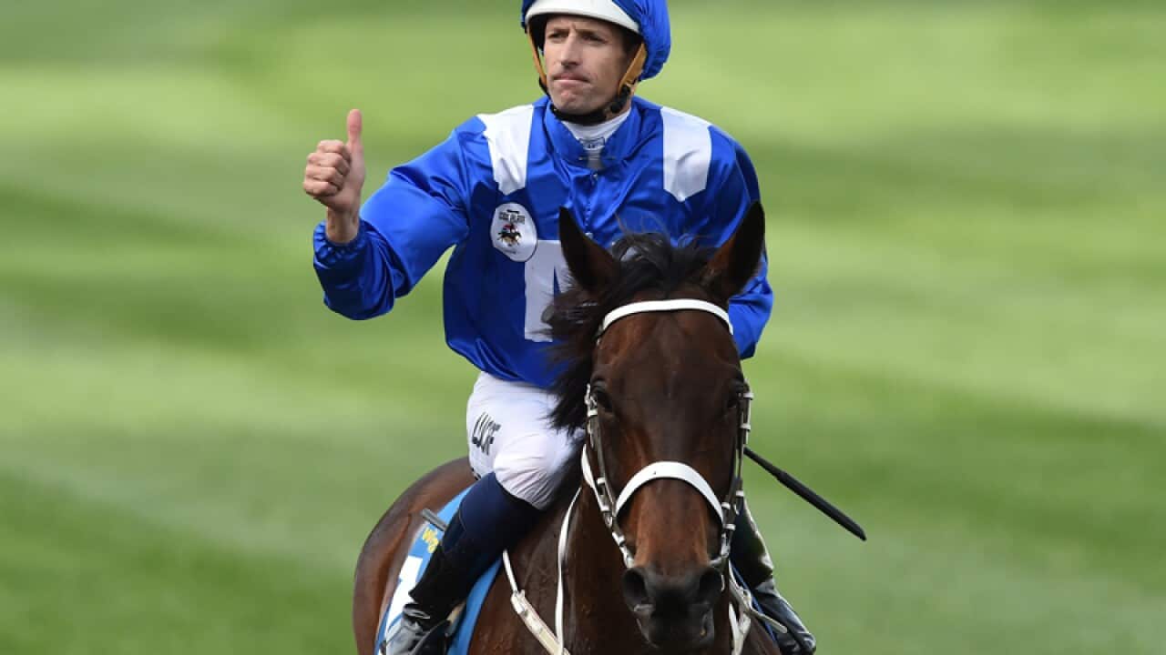 Hugh Bowman reacts after riding Winx to victory in the Cox Plate