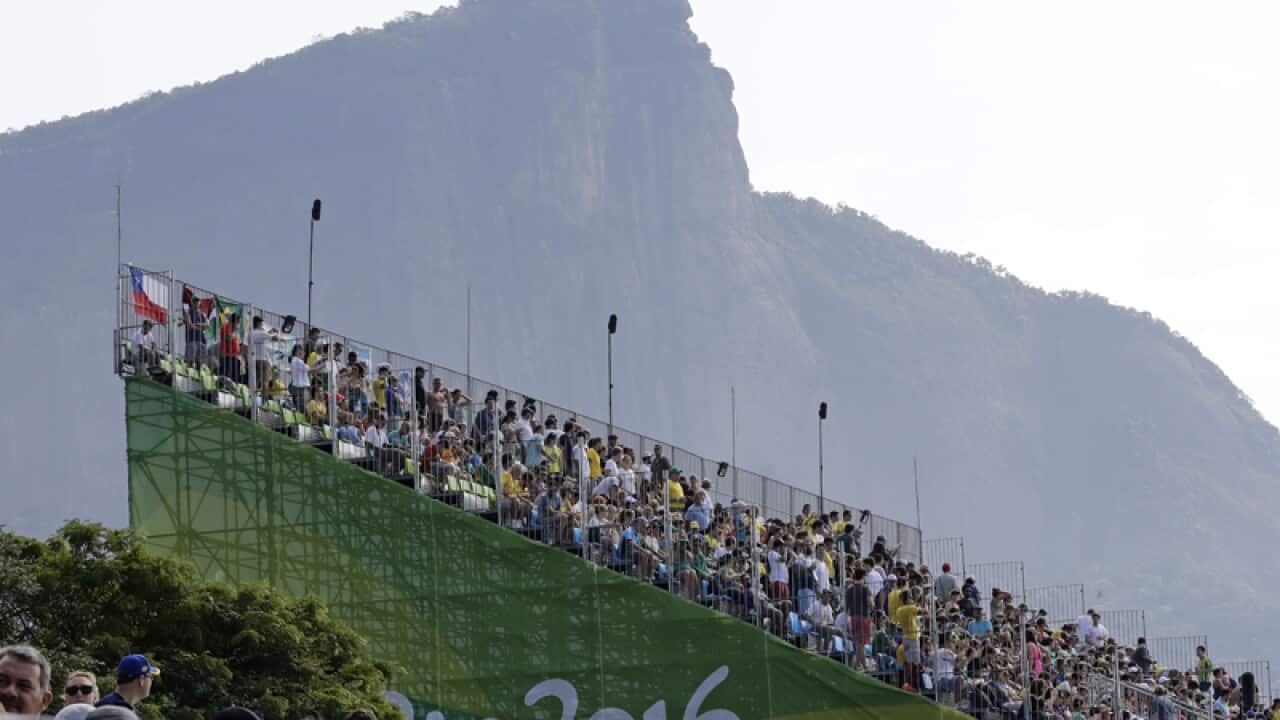 Fans watch competitors in the kayak during the Rio Olympics