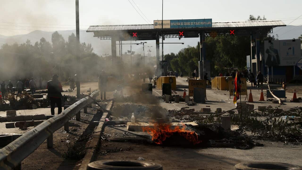 Tyres burn at a toll station in Sacaba in Bolivia on Saturday.