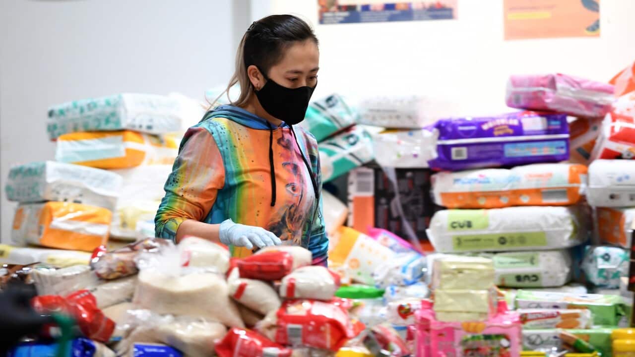 Volunteers organise supplies at the Australian Muslim Social Services Agency in North Melbourne