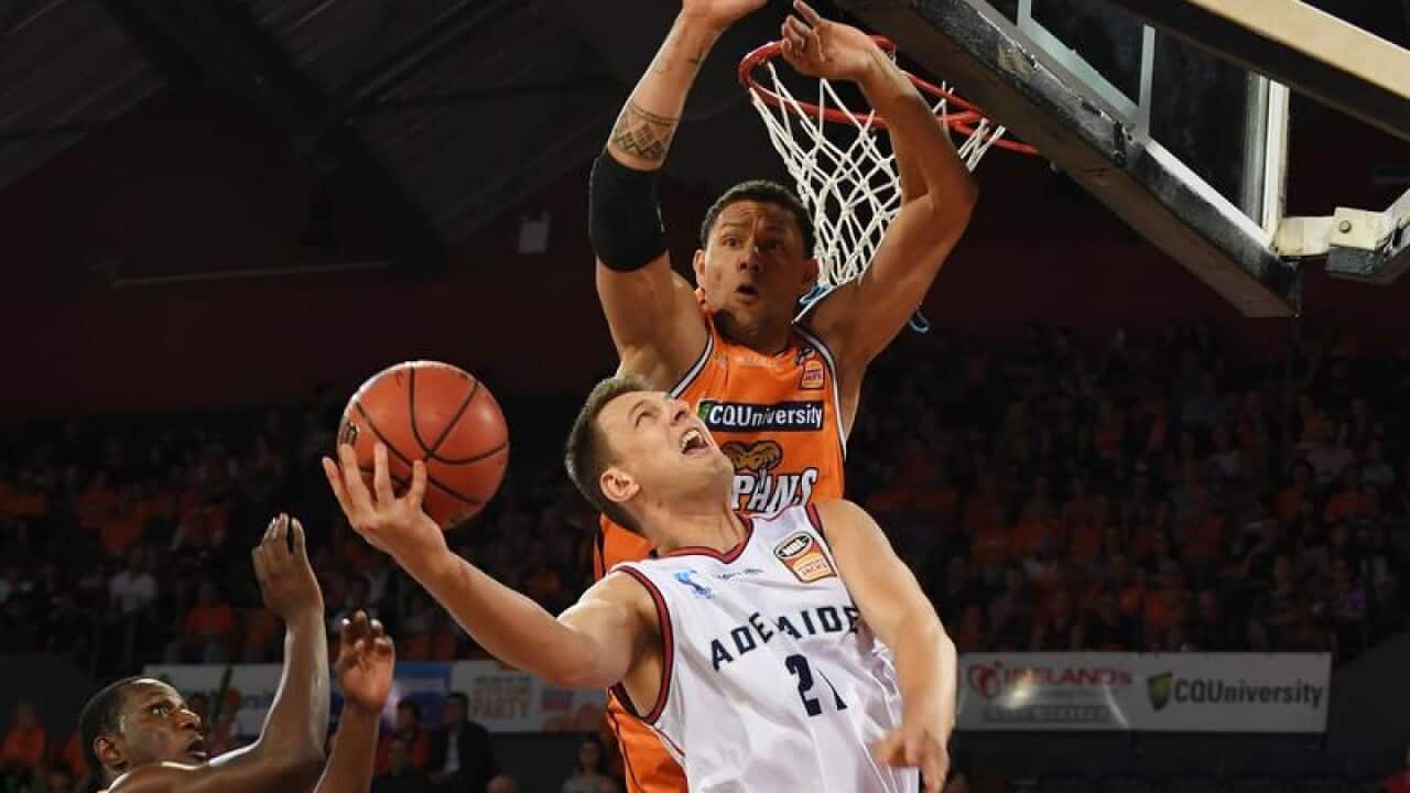 Daniel Johnson of the Adelaide 36ers blocked Taipans player.