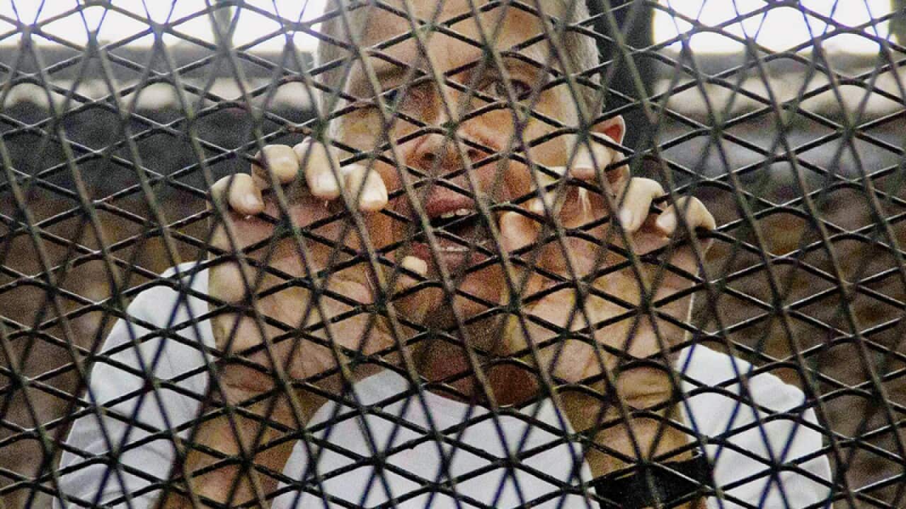 Peter Greste appears at a courthouse near Tora prison in Cairo