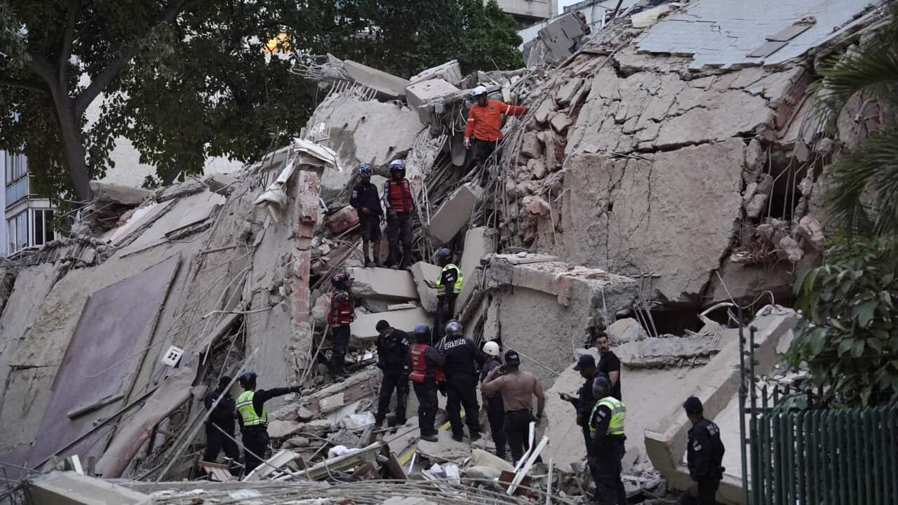 People searching in the rubble of a building.