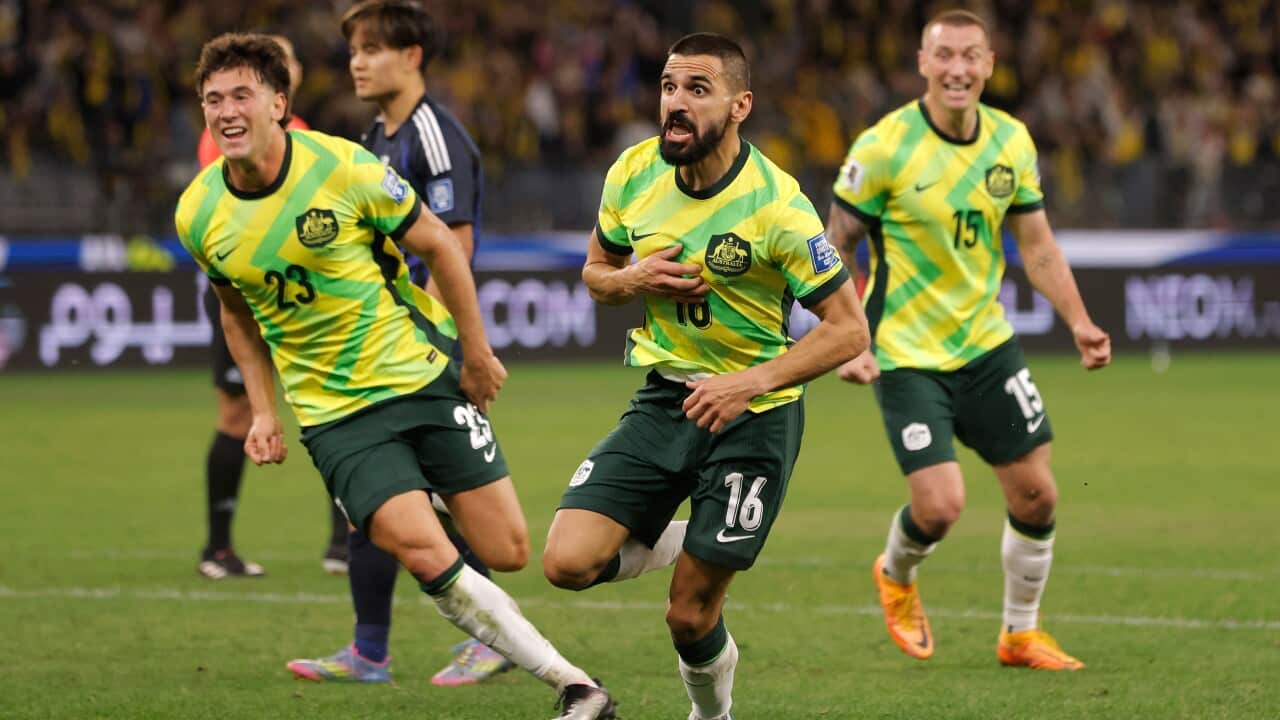 Players in yellow and green football shirts celebrate
