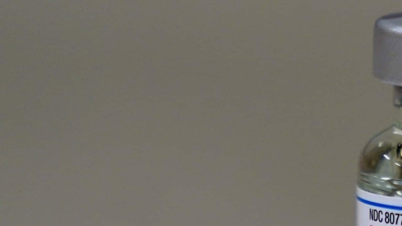 A bottle of Moderna's COVID-19 vaccine is seen on a table before Kansas Democratic Gov. Laura Kelly received an injection Wednesday, Dec. 30, 2020, in Topeka, Kan. (AP Photo/Charlie Riedel)