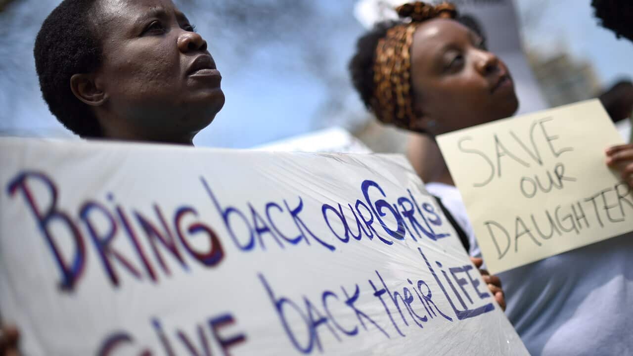 Participants display placards during a vigil in the United States for the missing Nigerian school girls