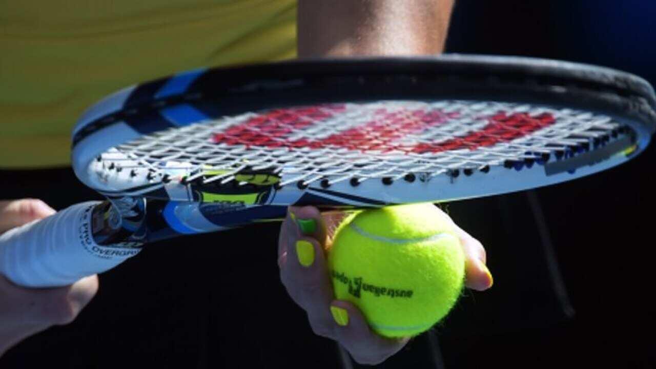 Tennis ball and a racquet