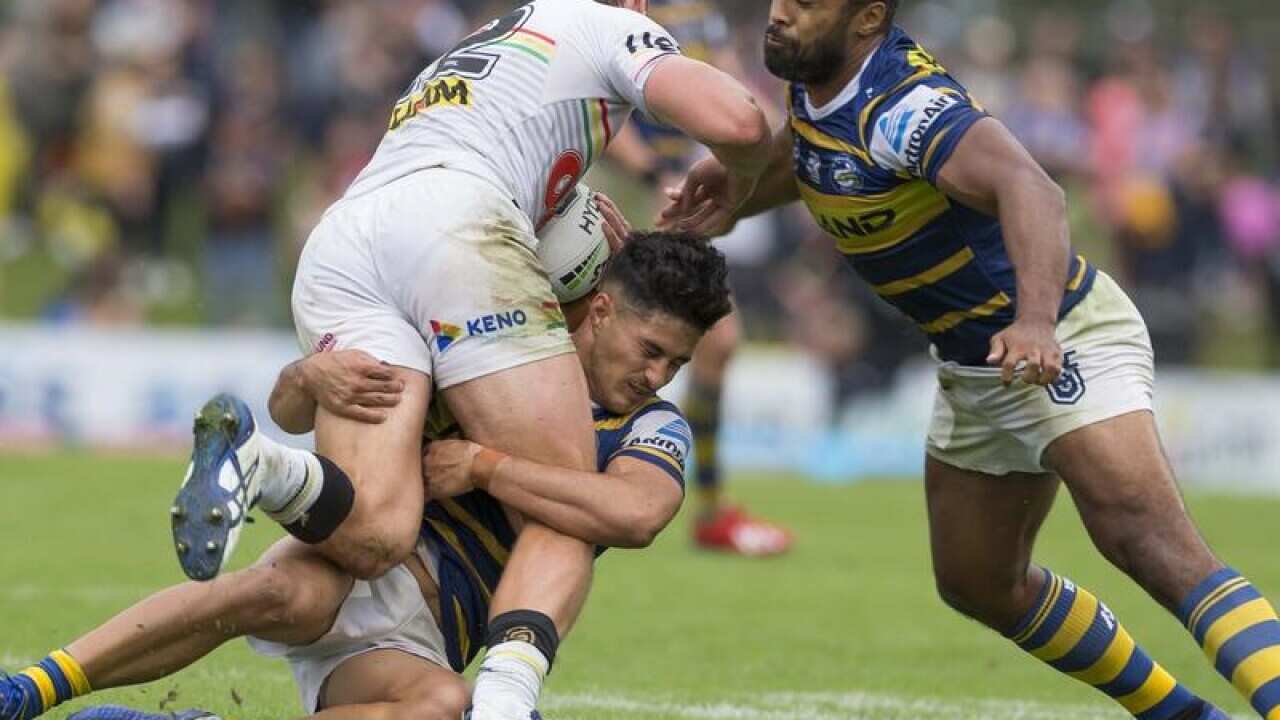 Dylan Brown (C) and Michael Jennings (R) tackle Isaah Yeo