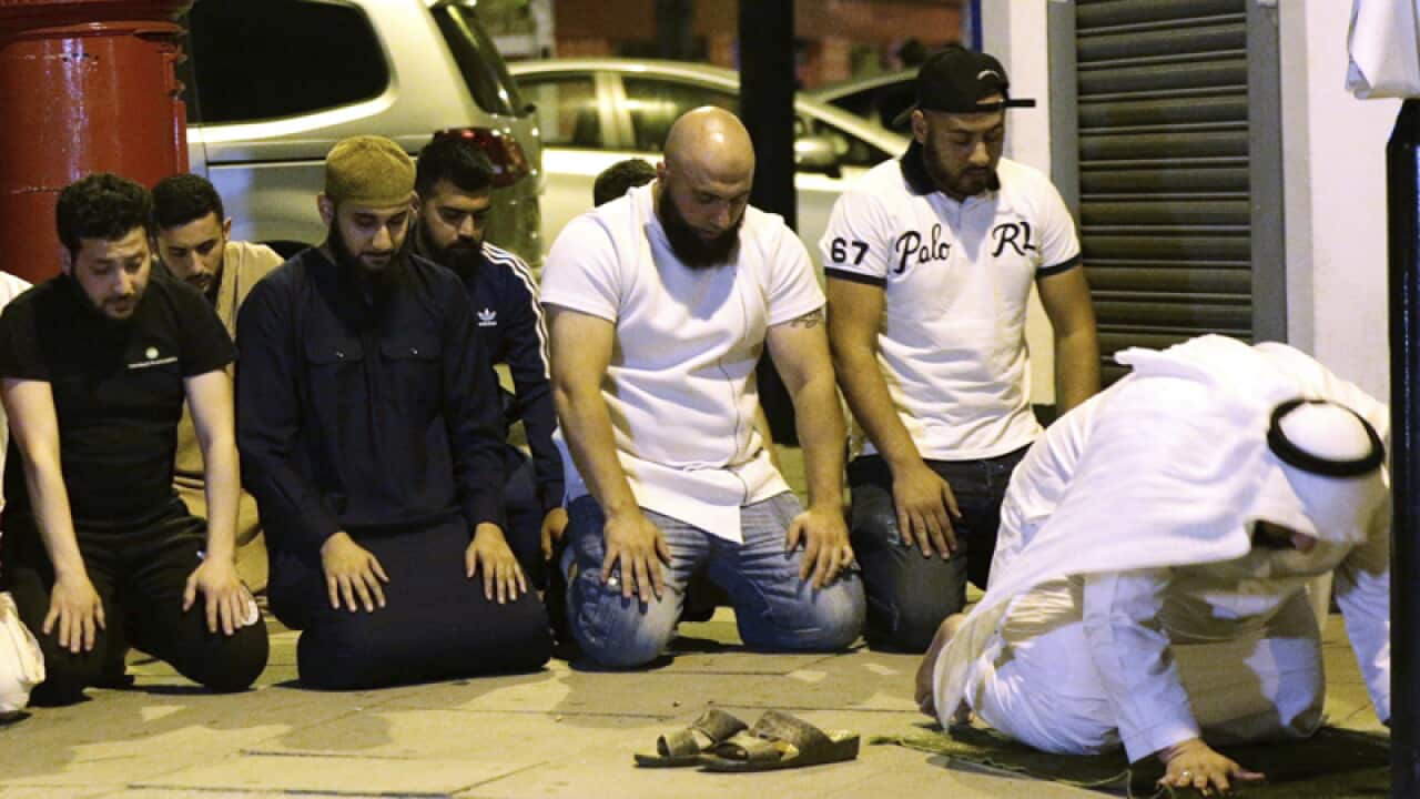 Locals pray at Finsbury Park in London after an attack