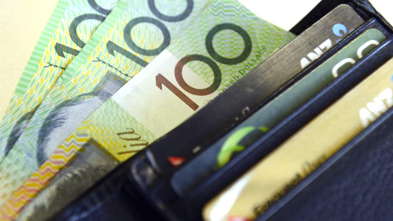 $100 Australian dollar notes pop out of a wallet
