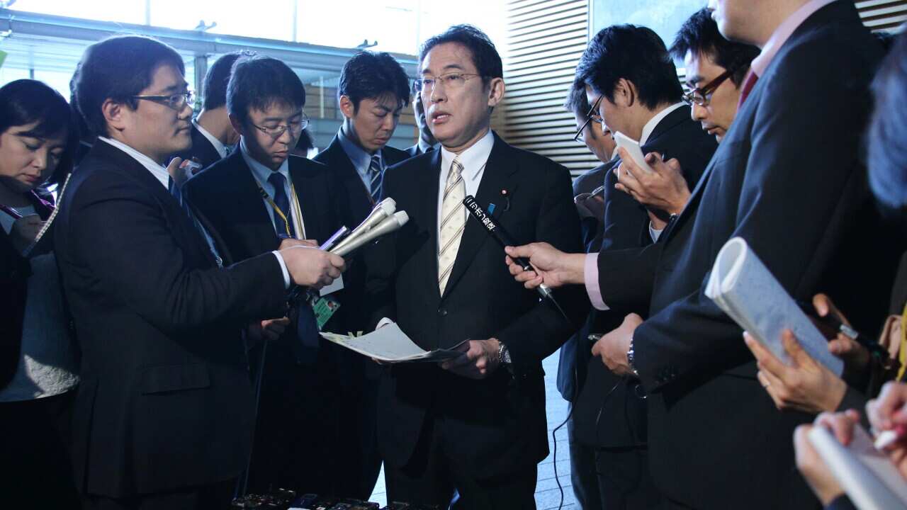 Foreign Minister Fumio Kishida speaks to reporters about the visit to South Korea to pave the way for a solution over the bilateral thorny issue “comfort women” during the World War 2