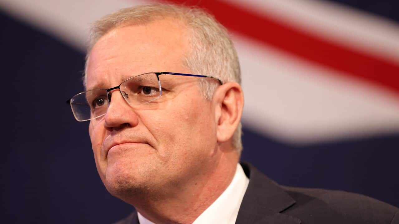 Scott Morrison in a suit and tie, wearing an Australian flag pin on his lapel.