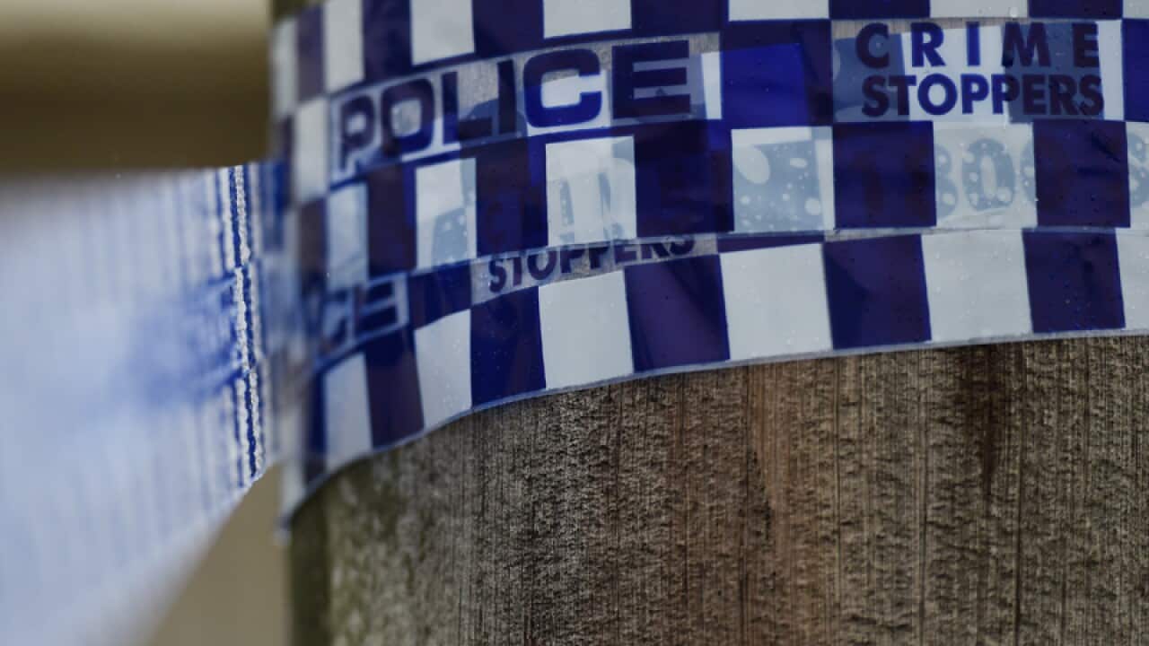 Police tape is seen at a home