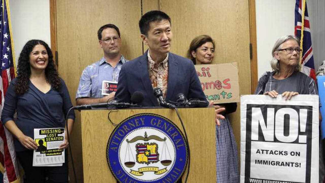 In this June 30, 2017 file photo, Hawaii Attorney General Douglas Chin speaks at a news conference in Honolulu about President Donald Donald Trump's travel ban.
