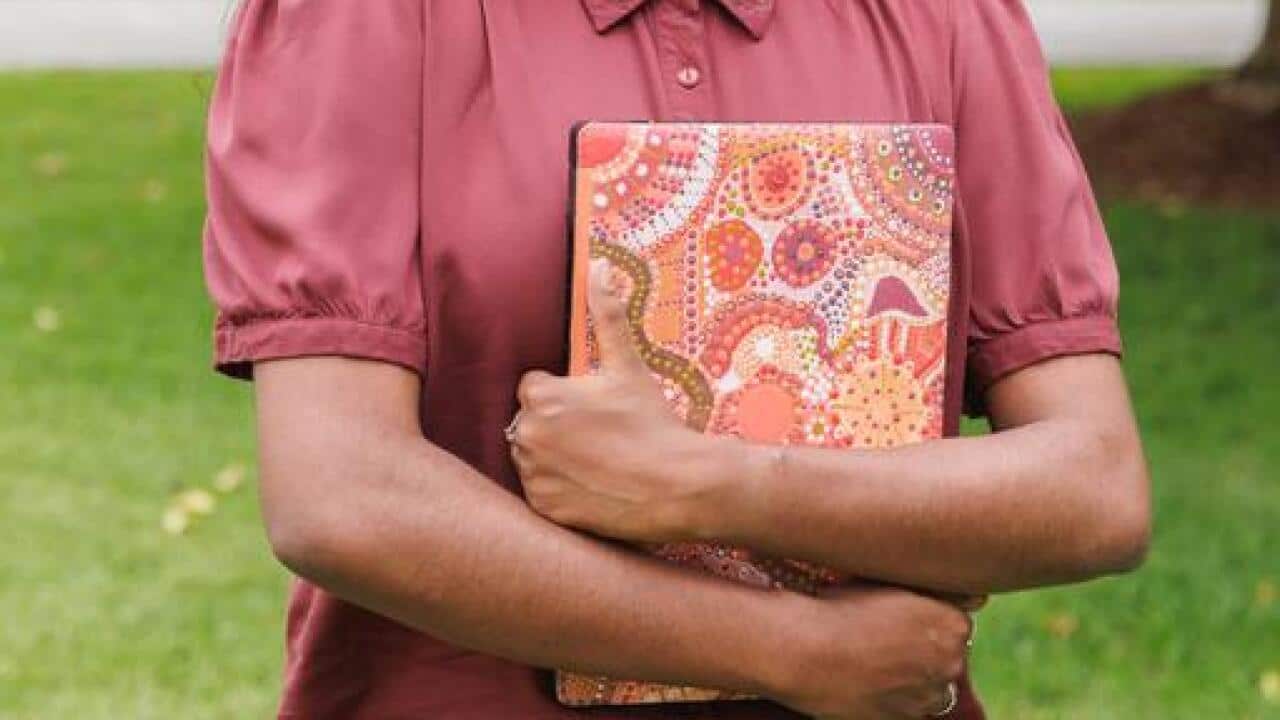 Student holding a laptop